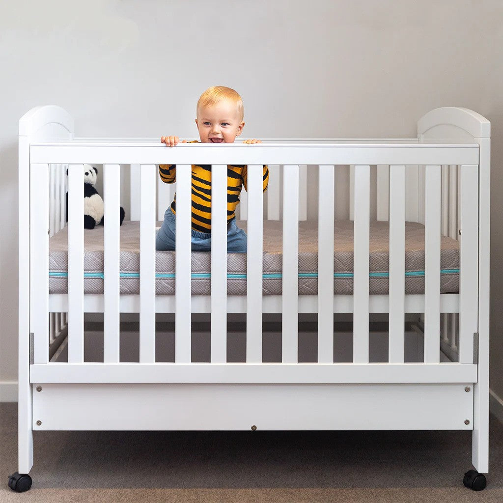 Baby on a cot mattress