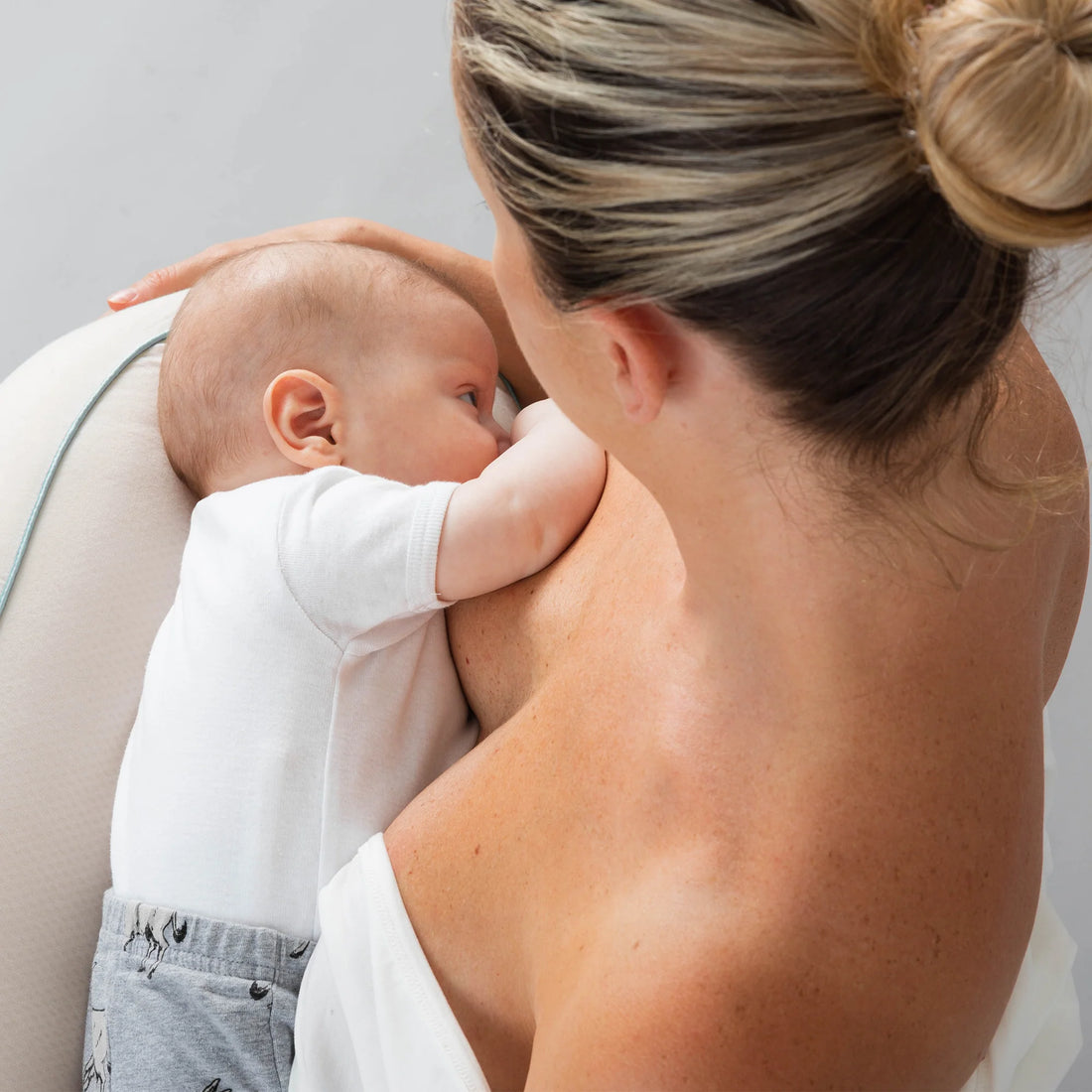 mum nursing baby with Growbright nursing pillow